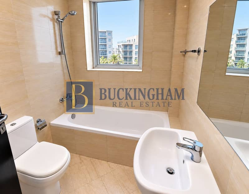 6 Modern Beige-Tiled Bathroom with Urban Window View. png