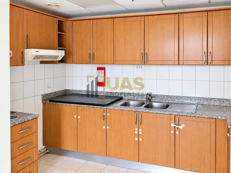 7 Bright honey-toned kitchen with granite counters. png
