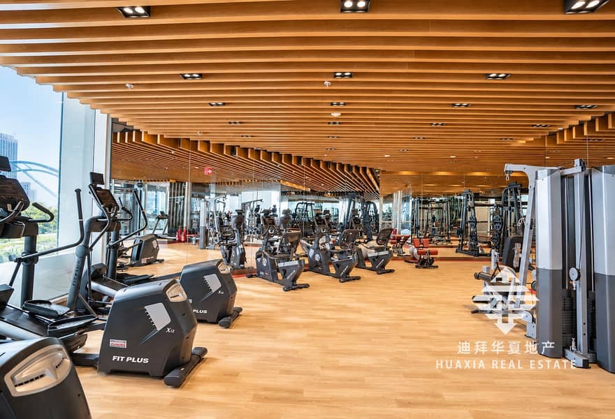 18 Bright Modern Gym Interior with Mirrors and Cardio Equipment. png