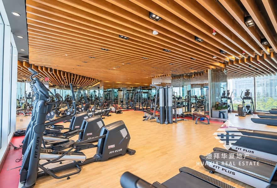 20 Bright Modern Gym Interior with FIT PLUS Equipment. png