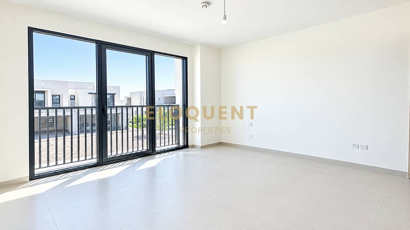10 Sunlit Minimalist Room with Balcony Views. png