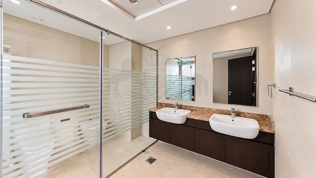 12 Modern Beige Bathroom with Glass Shower. png