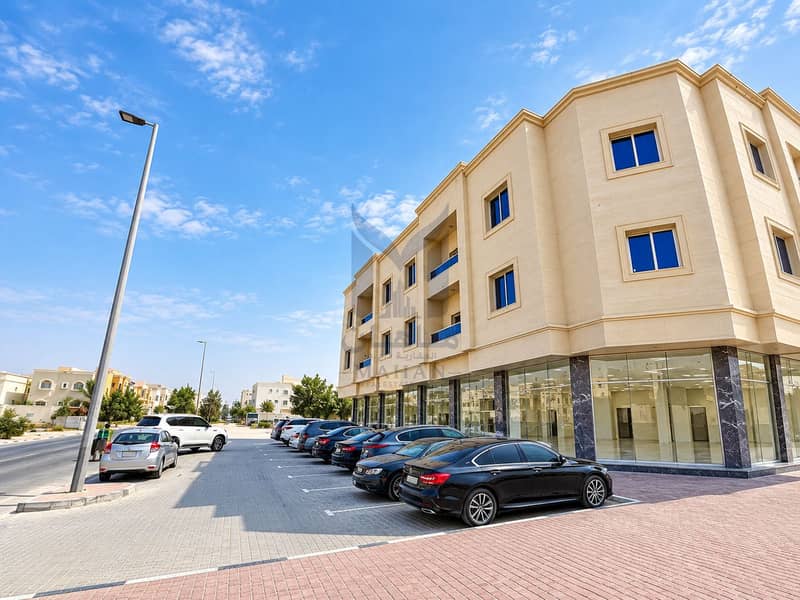 2 Modern Beige Corner Building and Parking Lot. png