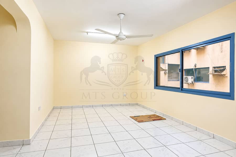 2 Empty Cream Room with Ceiling Fan and Window. png