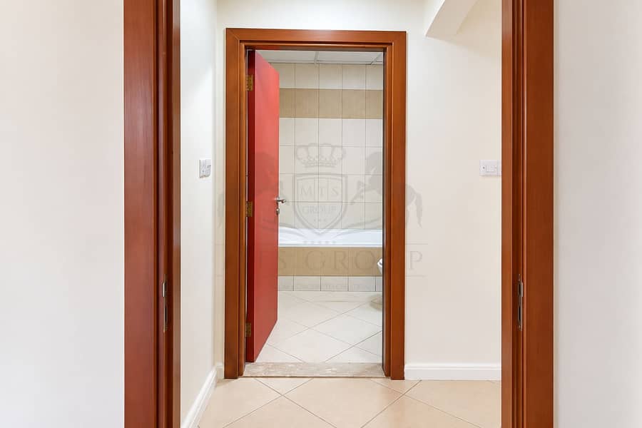 11 Reddish Doorway to a Bright Bathroom. png