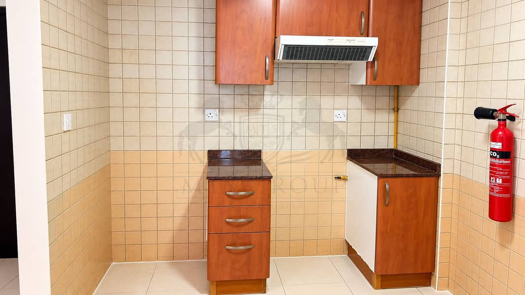 14 Compact Tiled Kitchen Nook with Red Fire Extinguisher. png