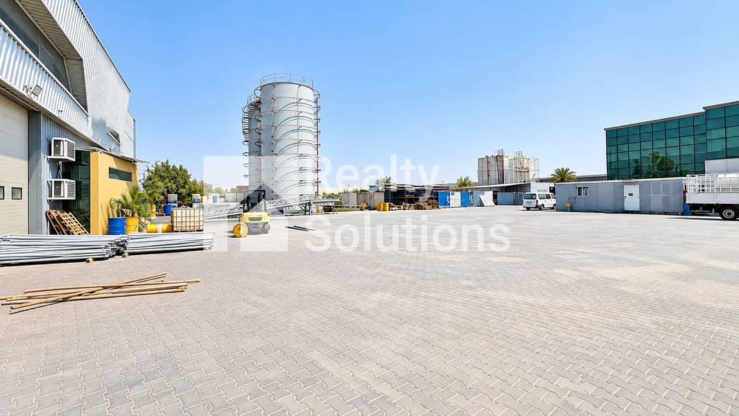 7 Bright Industrial Yard with Silo and Forklift. png
