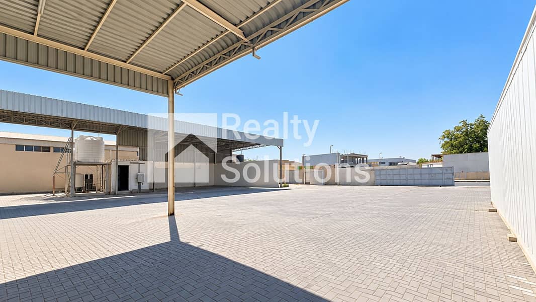 13 Sunlit Industrial Courtyard Under Canopy. png