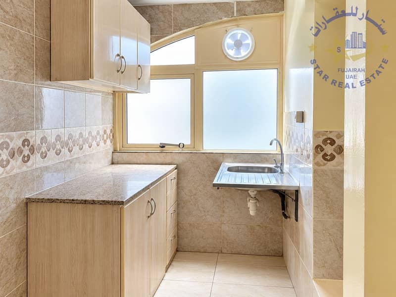 3 Bright Compact Galley Kitchen with Arched Window. png