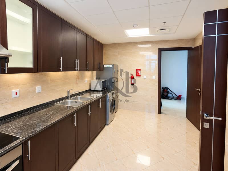 13 Modern Galley Kitchen and Laundry Alcove. png