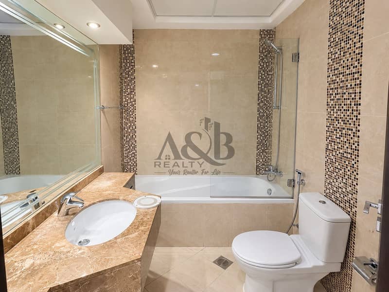 16 Bright Modern Beige-Tiled Bathroom. png