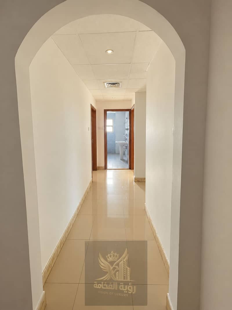4 Arched Hallway Leading to Tiled Bathroom. png