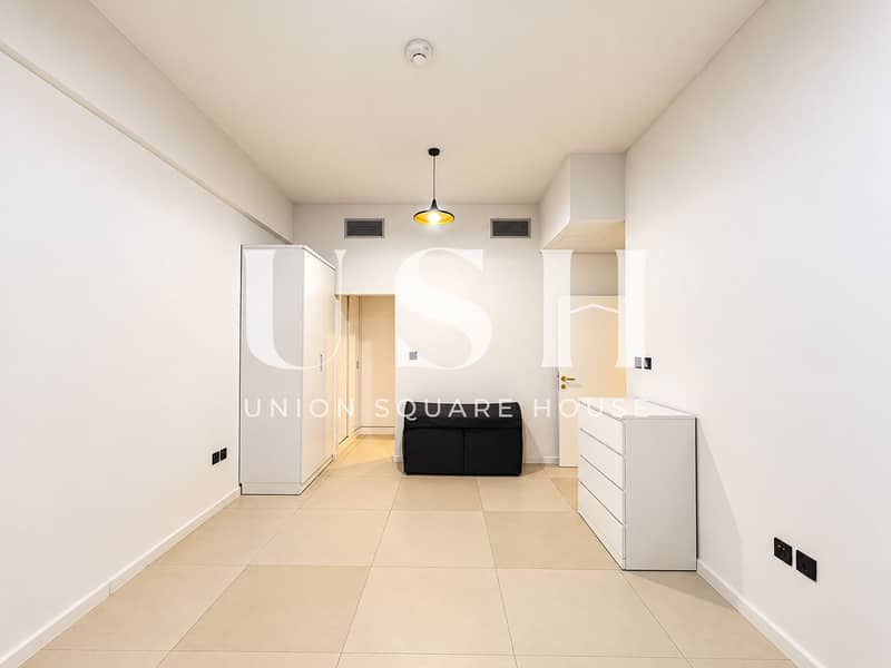 4 Minimalist Room with Warm Pendant Light. png