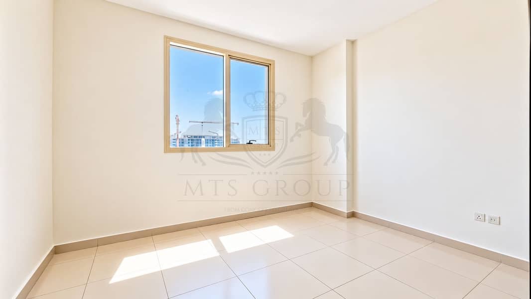 8 Sunlit Minimalist Room with Urban View. png