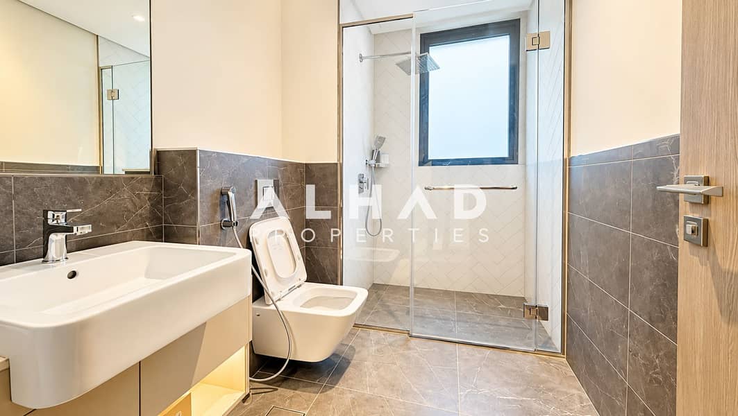 21 Modern Marble-Tiled Bathroom. png