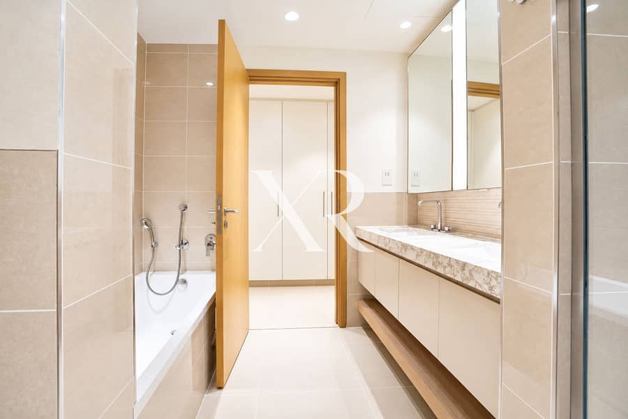 15 Modern Beige Bathroom with Open Closet Door. png