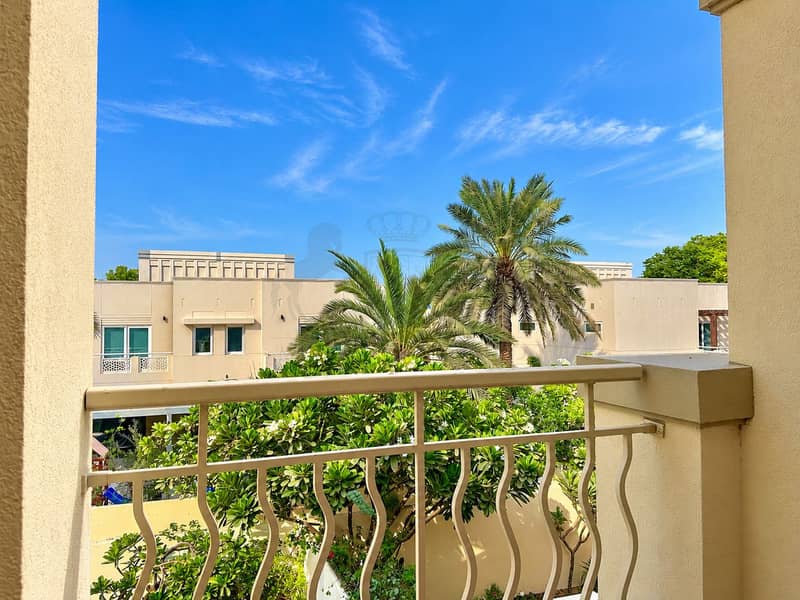 27 Sunny Balcony View of Palm-Filled Villas. png