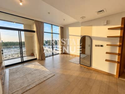 Studio for Rent in Majan, Dubai - Warmly lit interior with outdoor view-1. png