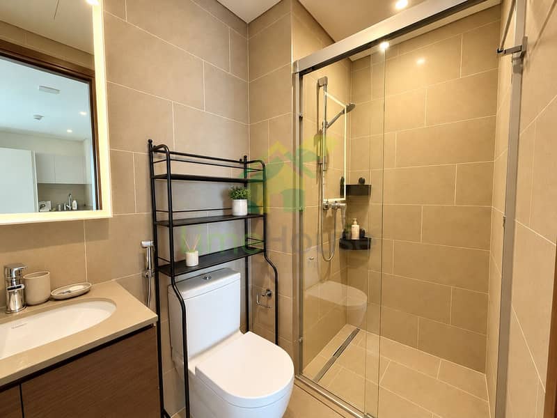 14 Warm Minimalist Bathroom with Glass Shower. png