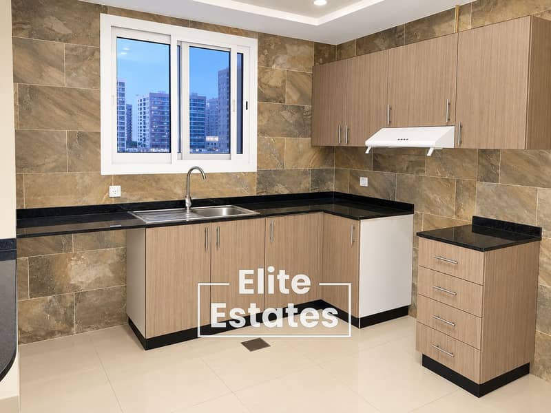 9 Modern L-Shaped Kitchen with City View. png