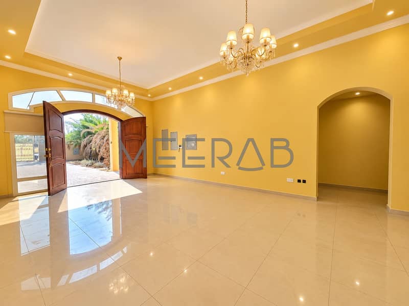 3 Warmly Lit Golden Foyer with Open Doors. png