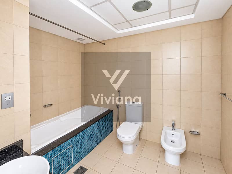 19 Modern Beige Bathroom with Blue Mosaic Tub Accents. png