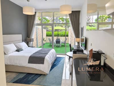 Hotel Apartment for Rent in Jumeirah Village Circle (JVC), Dubai - Bright Modern Studio Bedroom with Green Patio Views. png