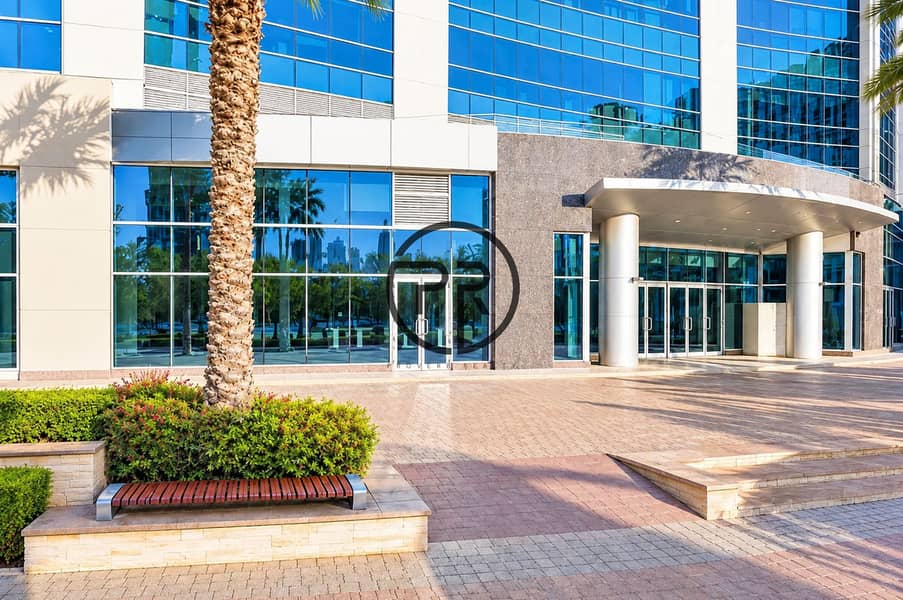 5 Modern Glass Office Entrance with Palm Landscaping. png