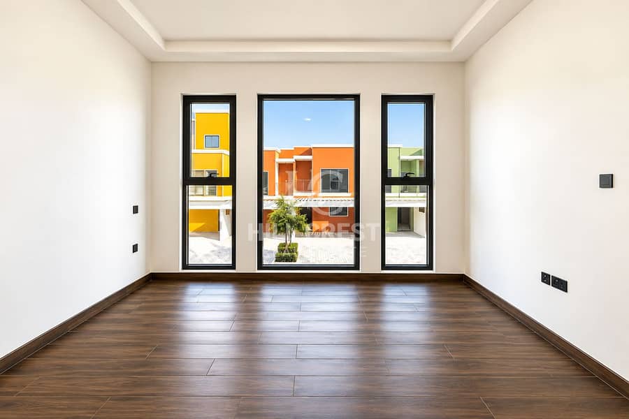 2 Bright Minimalist Room with Colorful Townhouse View. png