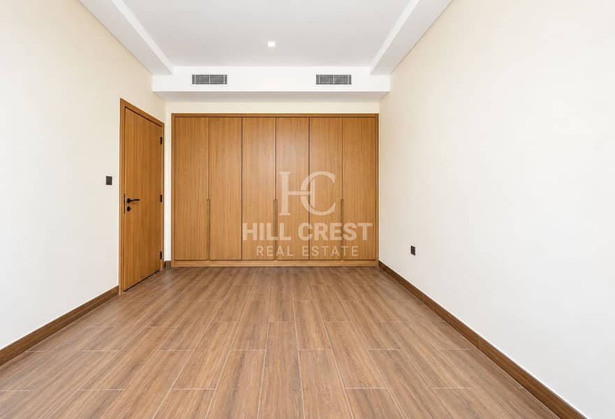 9 Modern Empty Wood-Toned Bedroom. png