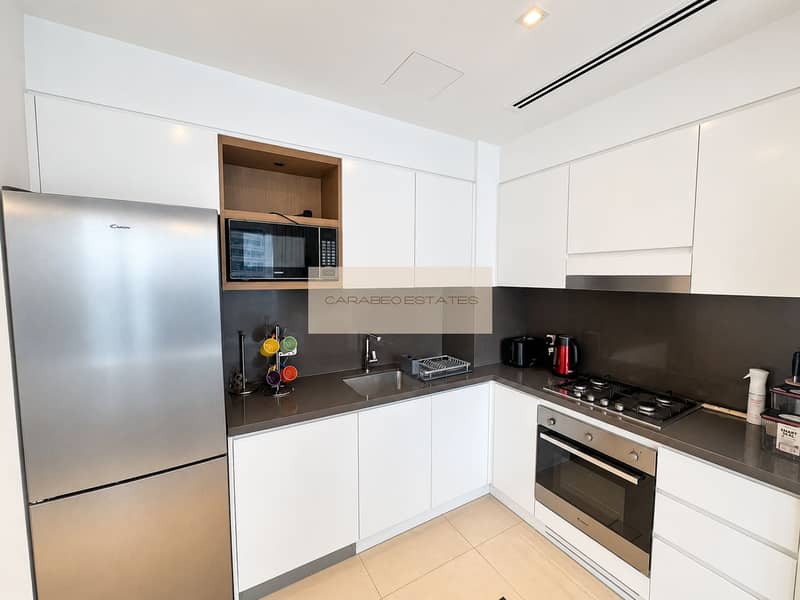 5 Bright, polished kitchen with stainless appliances. png