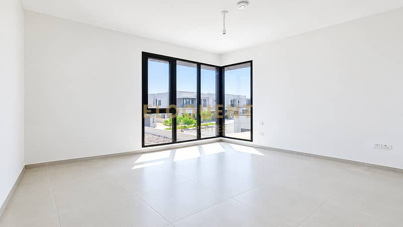 4 Bright Minimalist Room with Corner Windows. png