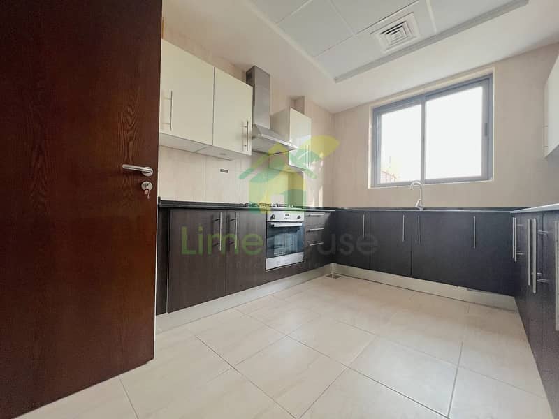 4 azizi-liatris-unit-310-kitchen-dark-cabinets-built-in-oven-gas-hob-al-furjan-dubai. jpg