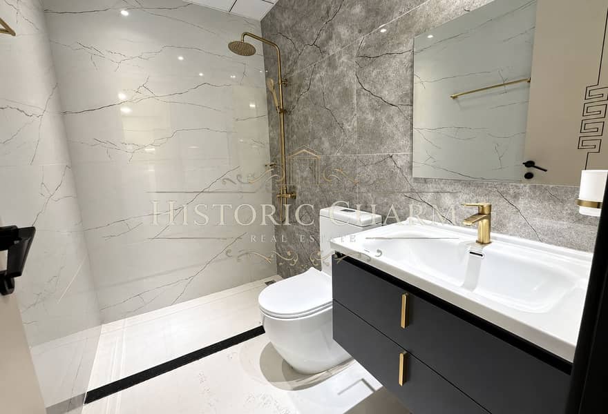 10 Modern Marble Bathroom with Brass Accents. png