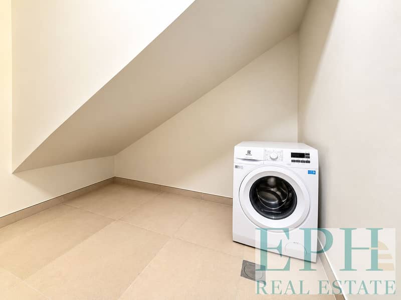 10 Minimal Under-Stairs Laundry Nook. png
