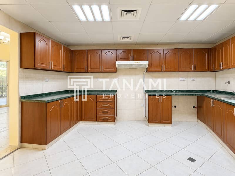 14 Bright Empty Kitchen with Warm Wood Cabinets. png