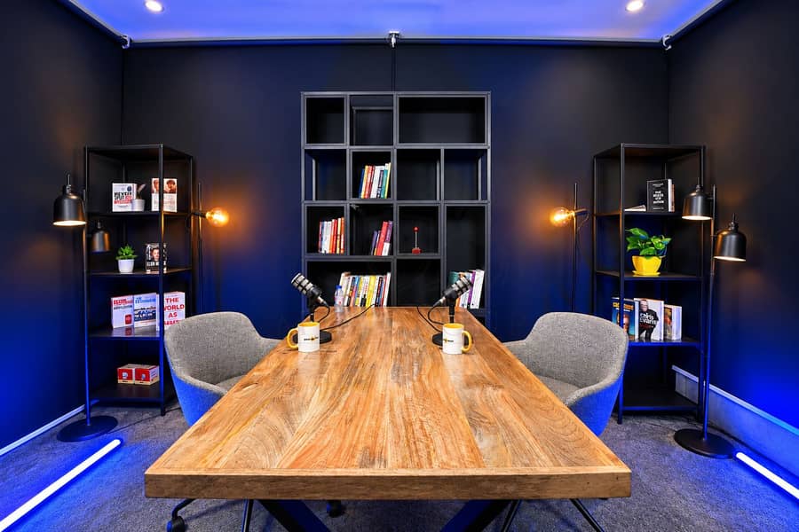 9 Modern Podcast Studio with Warm and Blue Lighting. png