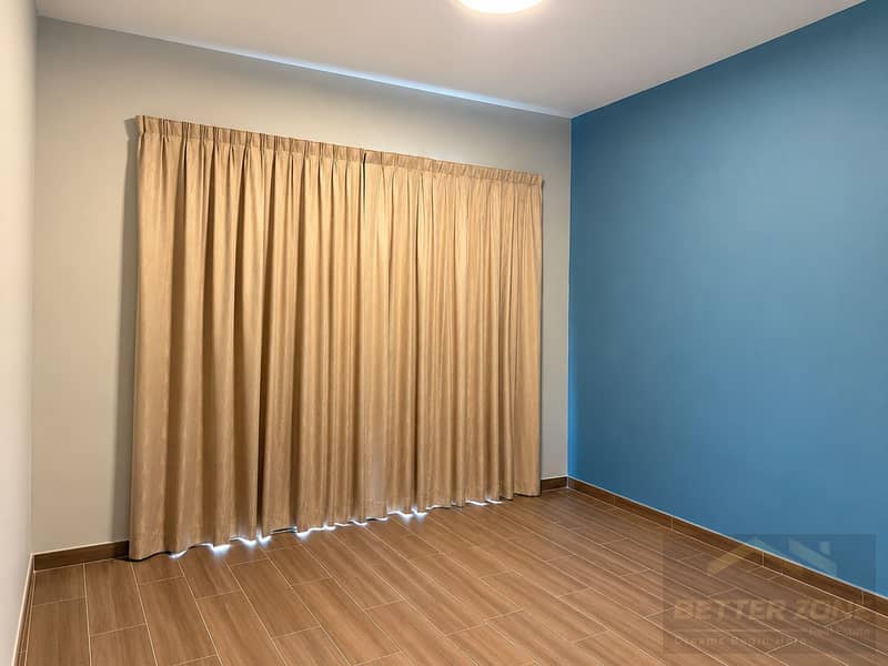 4 Minimalist Bedroom with Blue Accent Wall. png