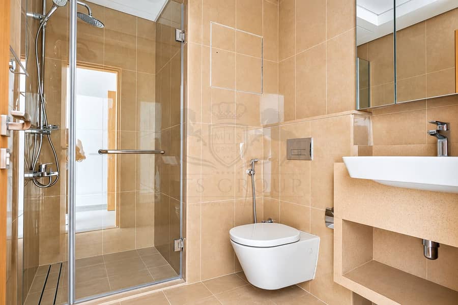 18 Modern Beige Bathroom with Glass Shower. png