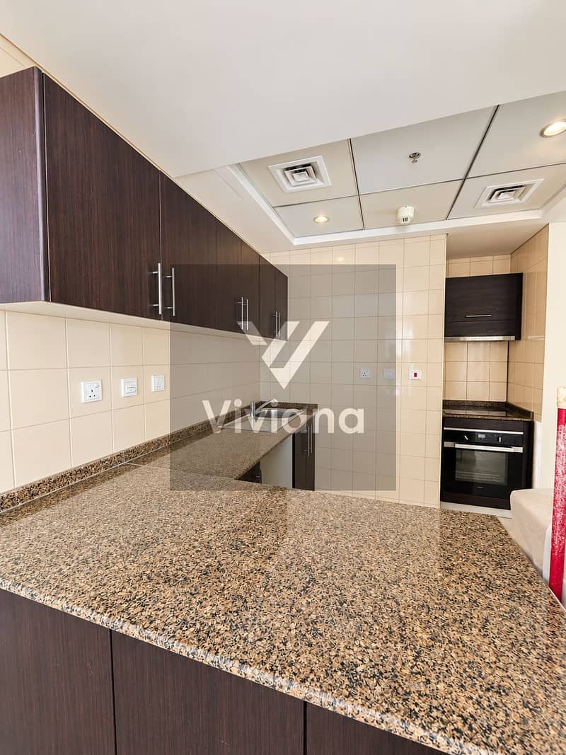 9 Modern Espresso Kitchenette with Granite Peninsula. png