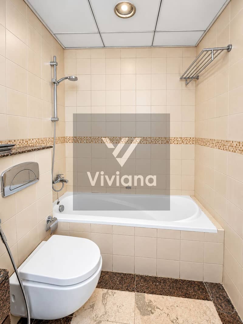 14 Modern Beige Tiled Bathroom with Bathtub. png