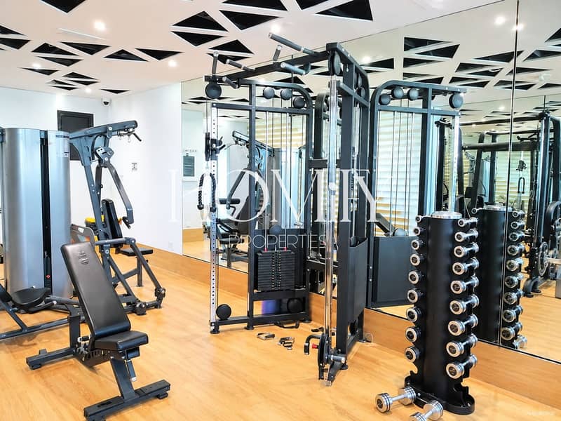 11 Modern Gym Interior with Mirrors and Equipment. png