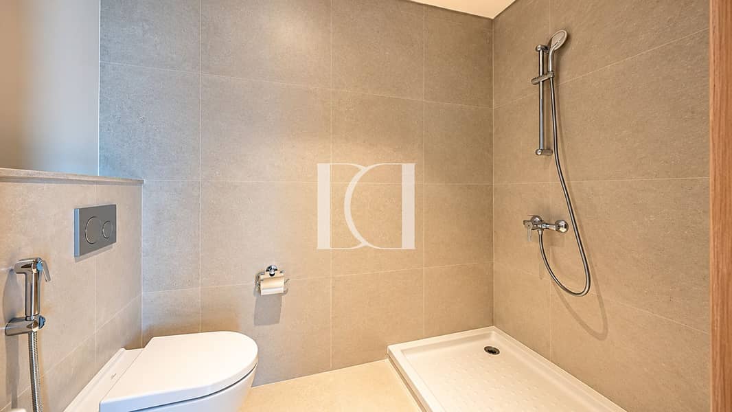 14 Minimalist Beige Tile Bathroom with Walk-In Shower. png