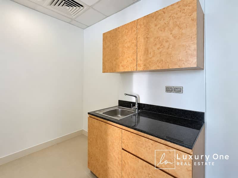 8 Minimalist Wood-Accented Kitchenette. png