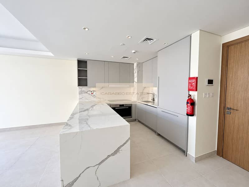 5 Bright, pristine kitchen and living area. png