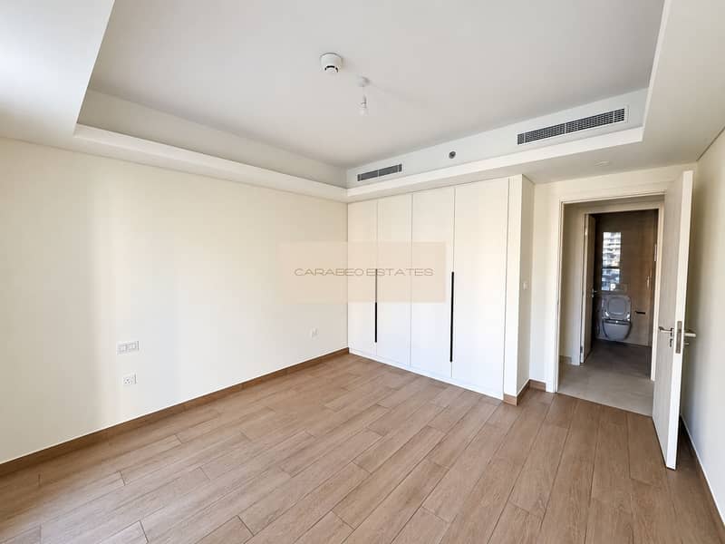 8 Bright Empty Bedroom With Bathroom Doorway. png