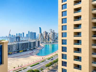 استوديو  للايجار في مدينة دبي للإنتاج، دبي - Modern Waterfront Cityscape with Tower and Lagoon. png