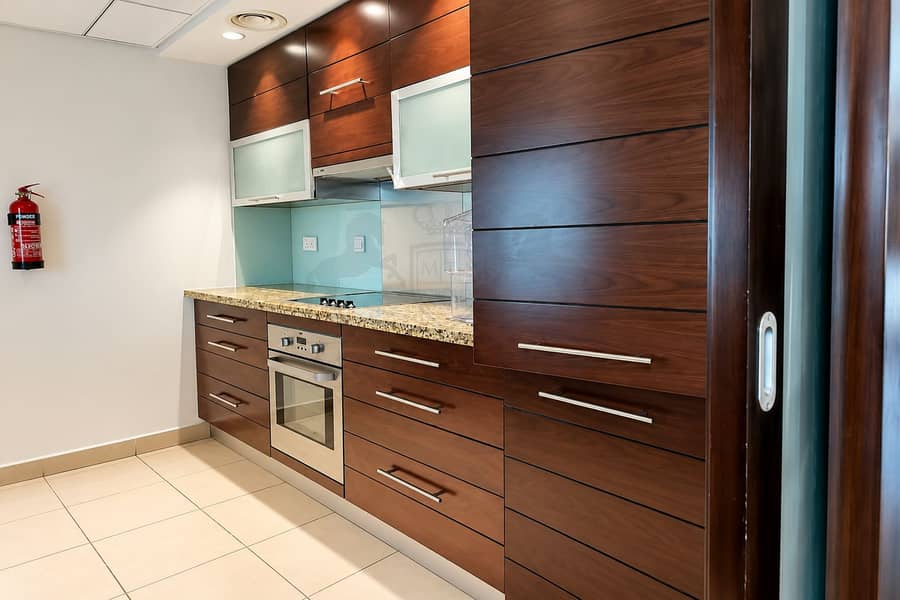 6 Modern Walnut Kitchen with Glass Backsplash. png