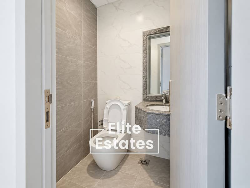 11 Modern Marble-Tiled Compact Bathroom. png