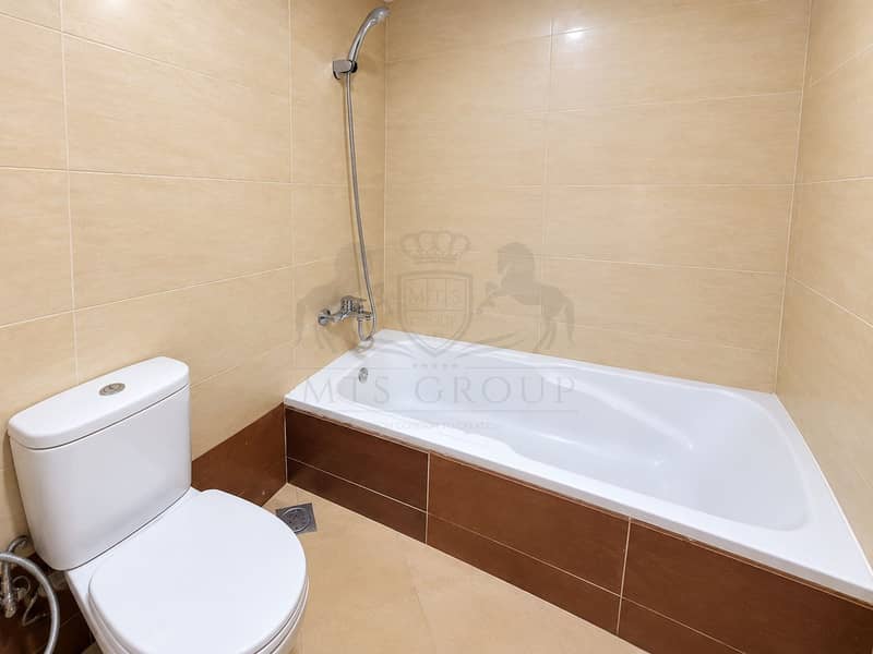 13 Modern Beige Tiled Bathroom with Bathtub. png